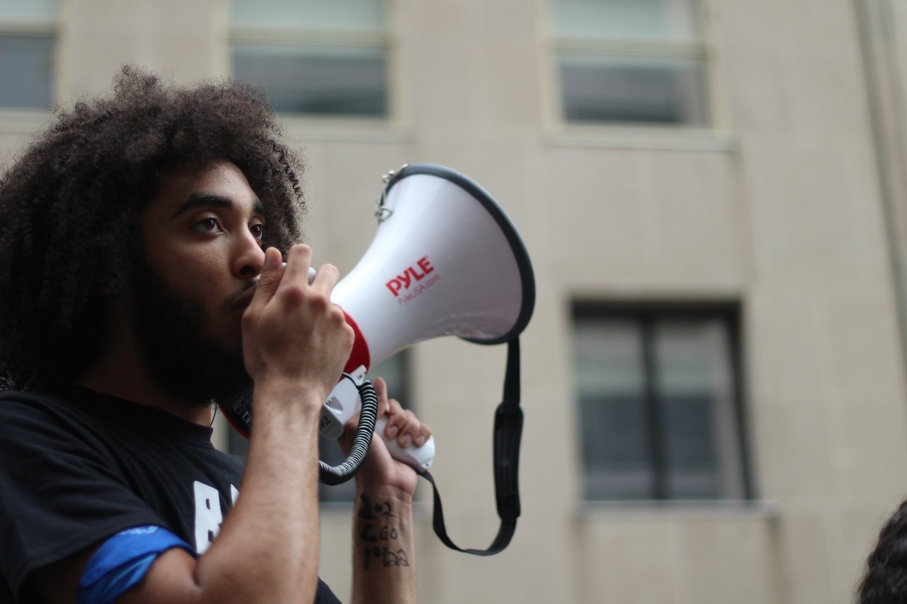 Person holding and speaking through a megaphone