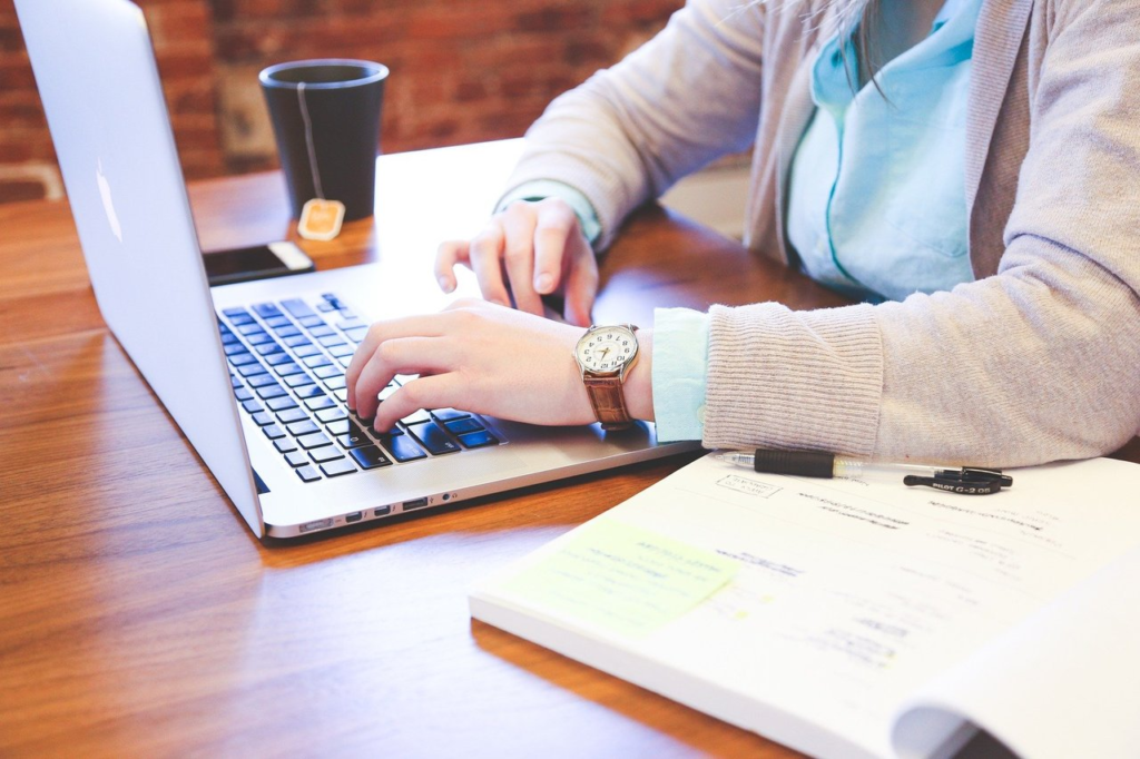 Person on a computer with a book