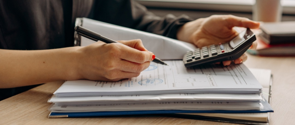 Person going through accounts with a calculator